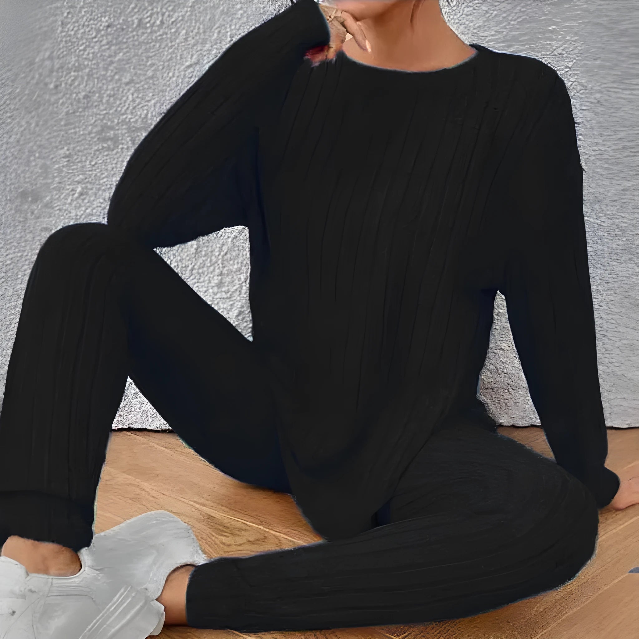 Black sunken stripe two-piece loungewear set with top and trousers on a hanger.