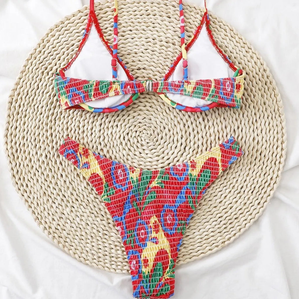 Red floral patterned women's underwire triangle bikini top and briefs on a mannequin.
