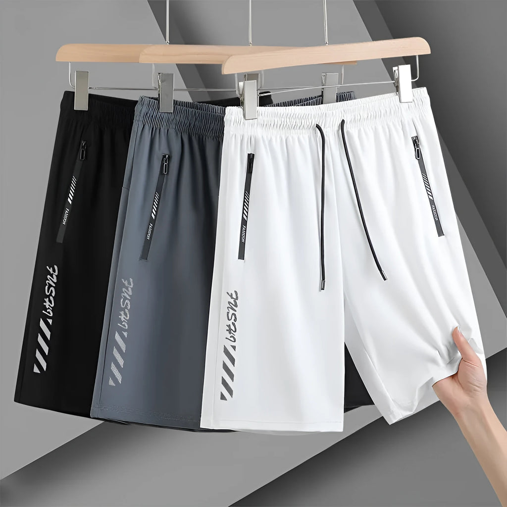 Man wearing black quick-dry nylon sports shorts with a loose fit and elastic waistband.
