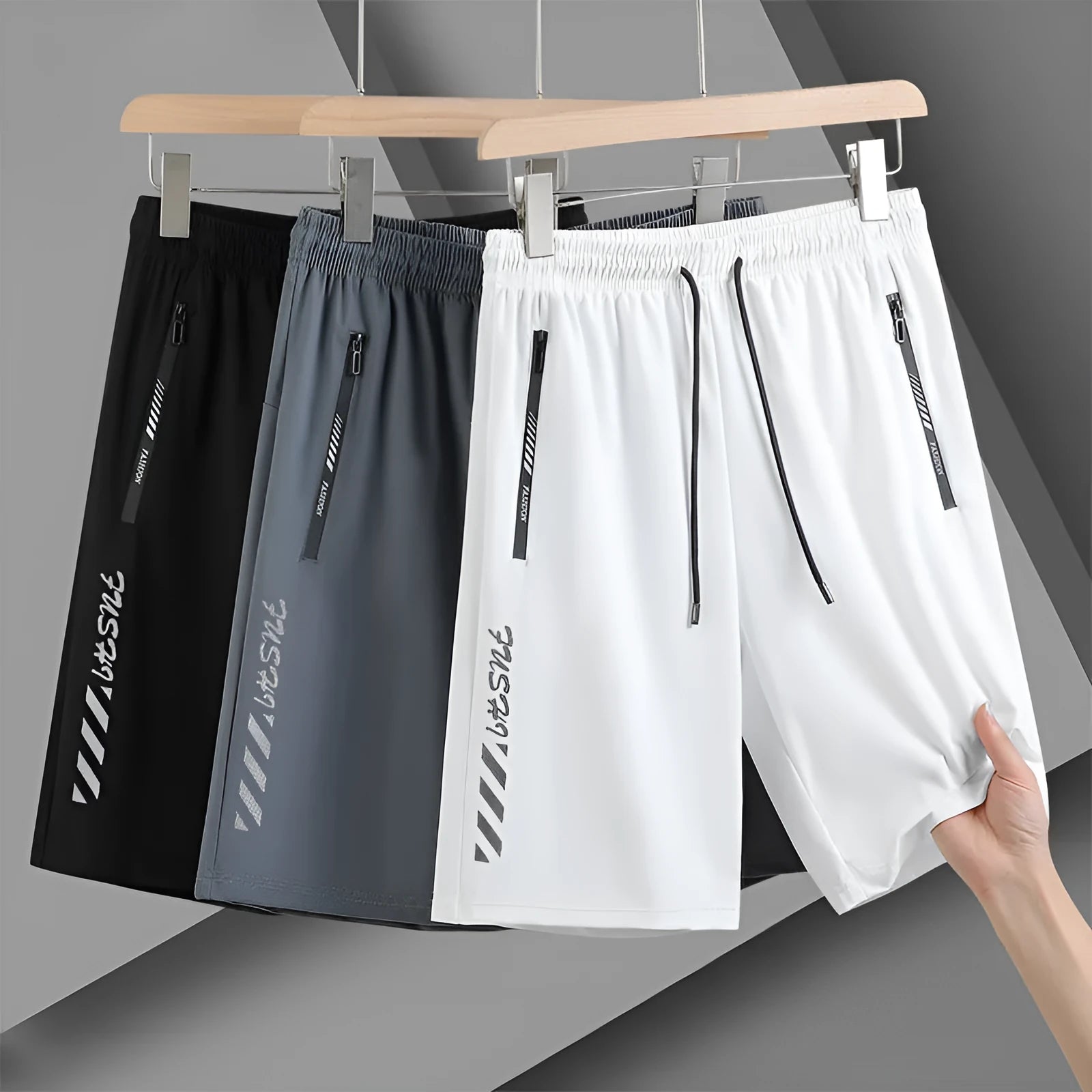 Man wearing black quick-dry nylon sports shorts with a loose fit and elastic waistband.