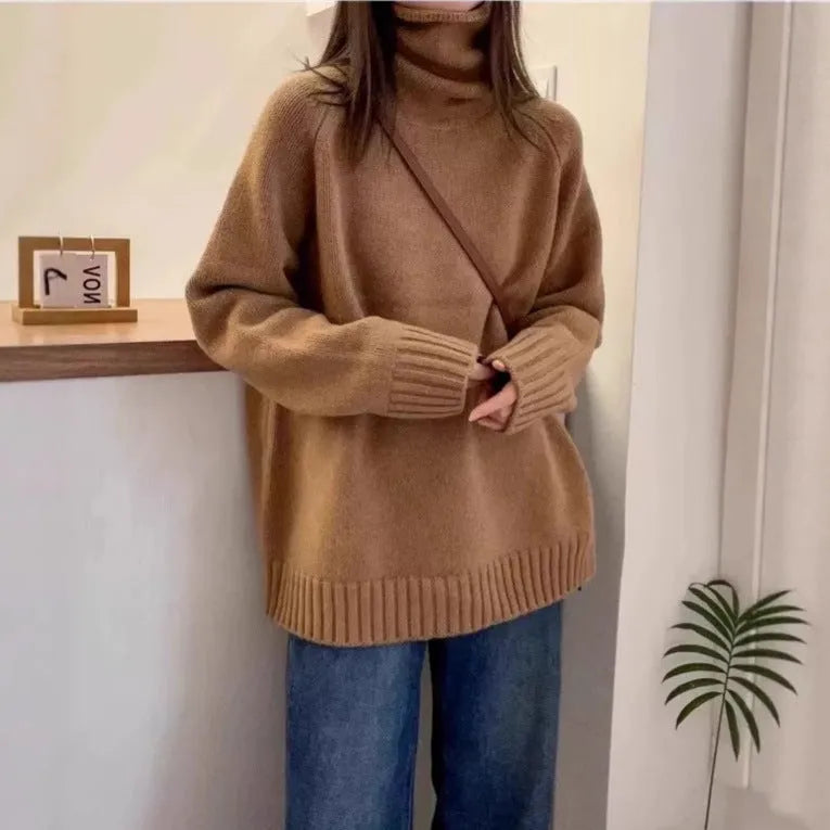 Women's loose fit turtleneck sweater with a thick, textured curling pile collar in a solid colour.