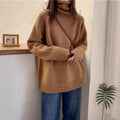 Women's loose fit turtleneck sweater with a thick, textured curling pile collar in a solid colour.