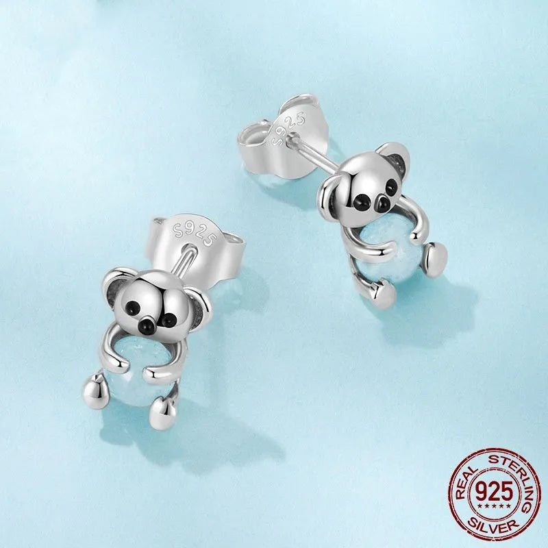 S925 sterling silver dangling koala bear earrings with dripping oil finish on a white background
