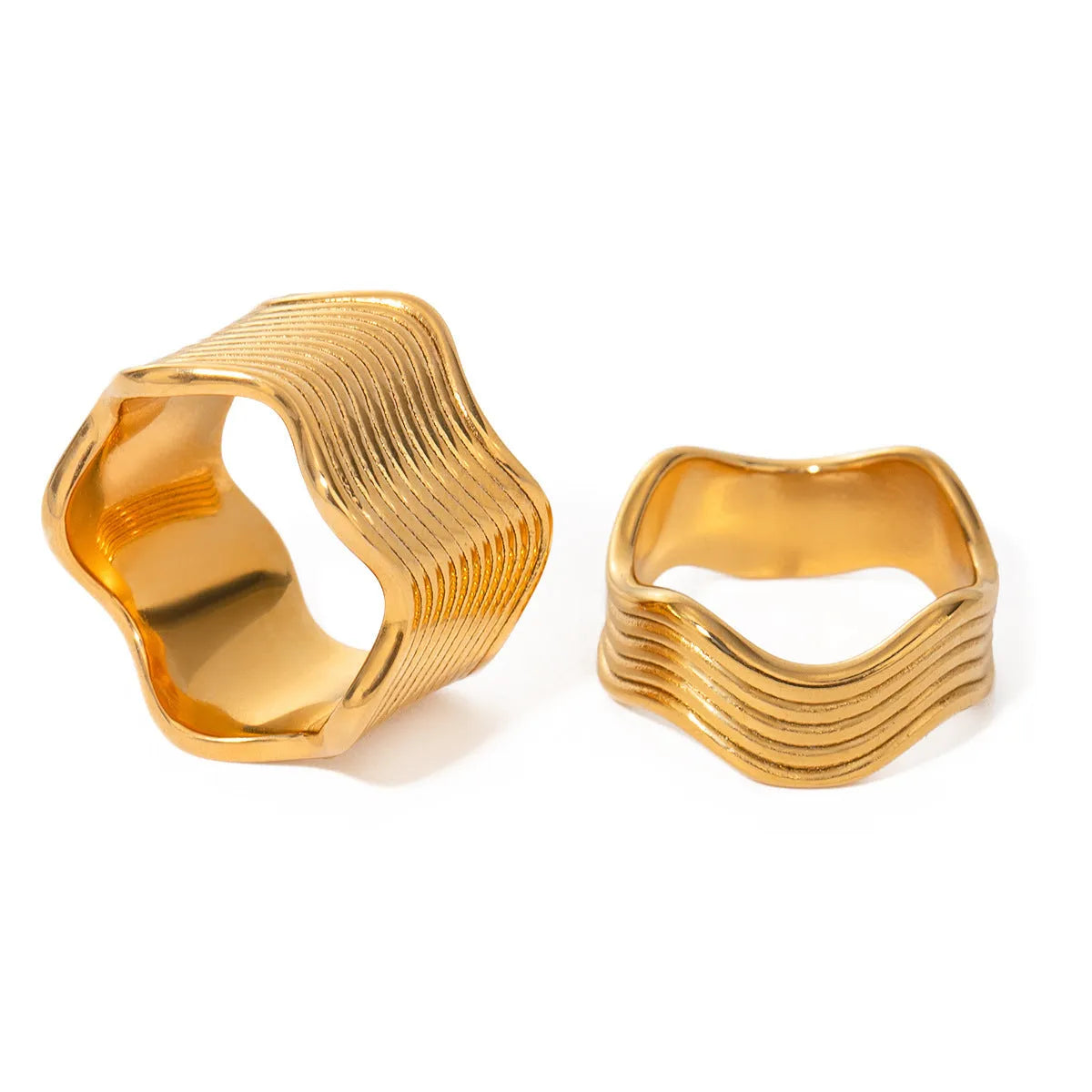 Stainless steel geometric wave ring with wide band and electroplated finish.