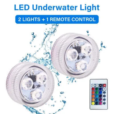 Small white rectangular LED diving light with cable next to a multi-button remote control on a blue background.