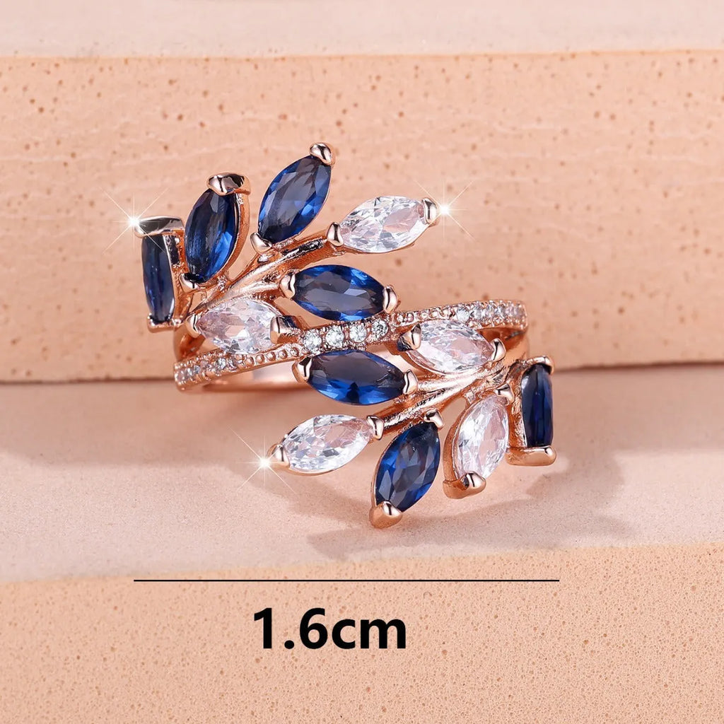 Adjustable copper leaf-shaped ring with sparkling zircon stones in rose gold and platinum finishes.