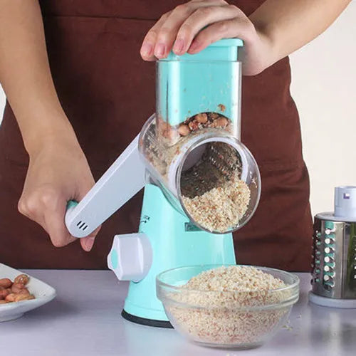 Blue round manual mandoline slicer with stainless steel blade for vegetables on a kitchen counter.
