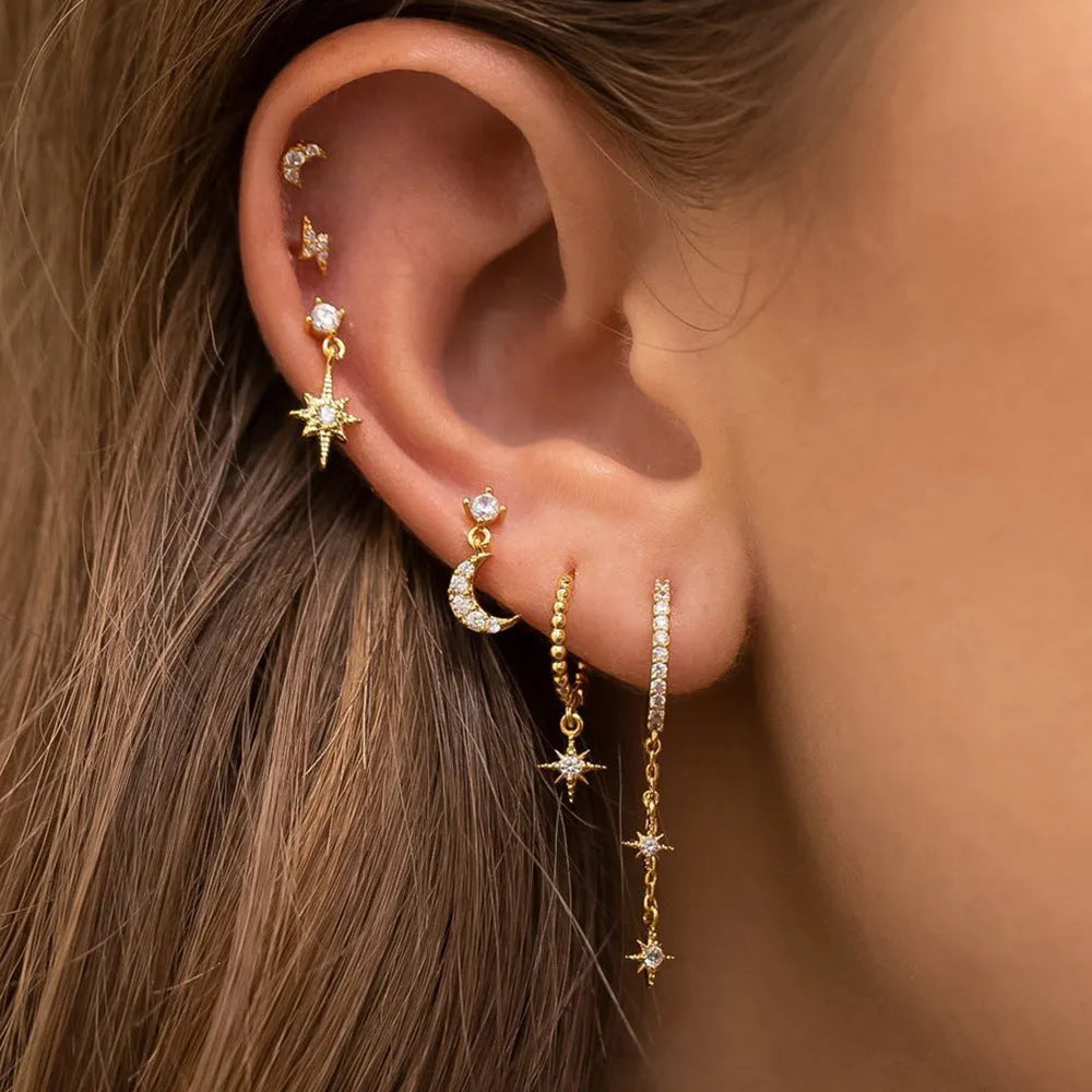 Six gold chain tassel earrings with zircon studs arranged as a complete jewellery set