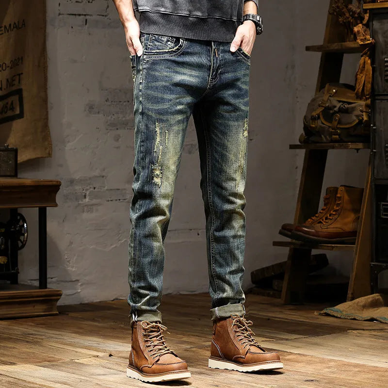 Men's skinny fit jeans in a retro blue wash with a zip fly, shown laid flat.