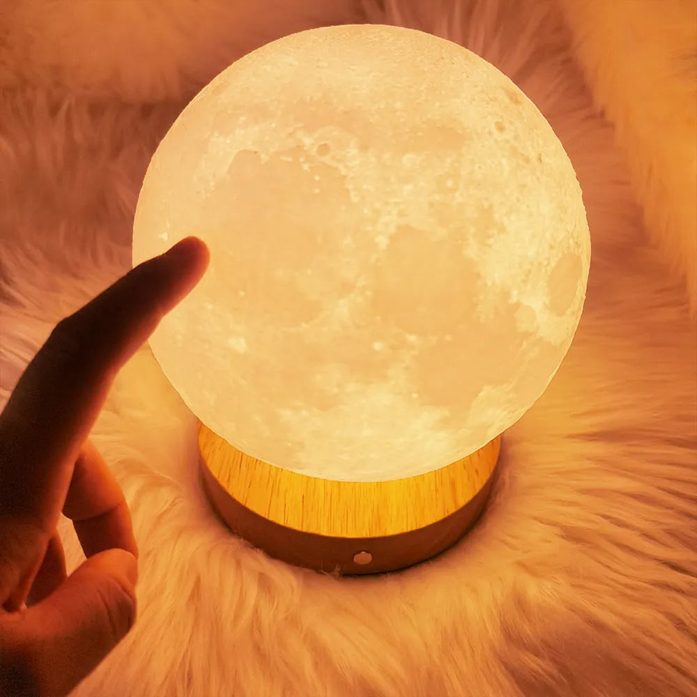 Rotating three-colour moon night lamp with wooden base in Nordic style, showing direct plug connection