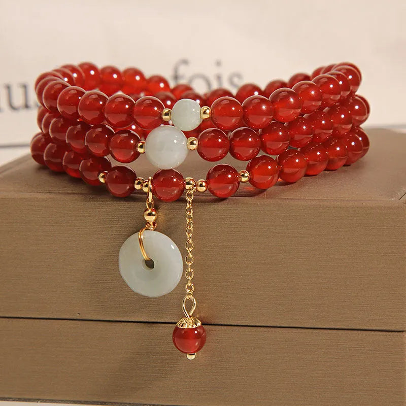 Red agate multi-layer crystal bracelet with a retro ethnic style on a white background.