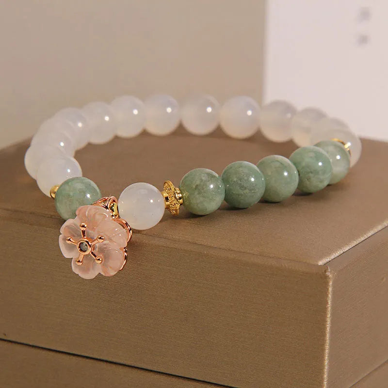 Women's floral bracelet made of white agate and jadeite stones set in jade.