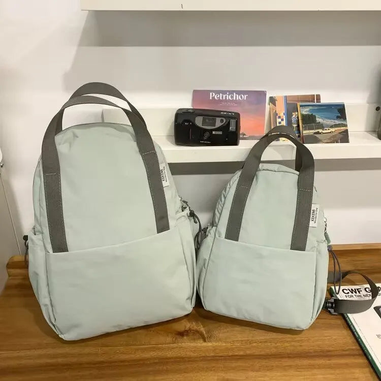 Simple solid colour ultra-light waterproof backpack with curved shoulder straps and lock
