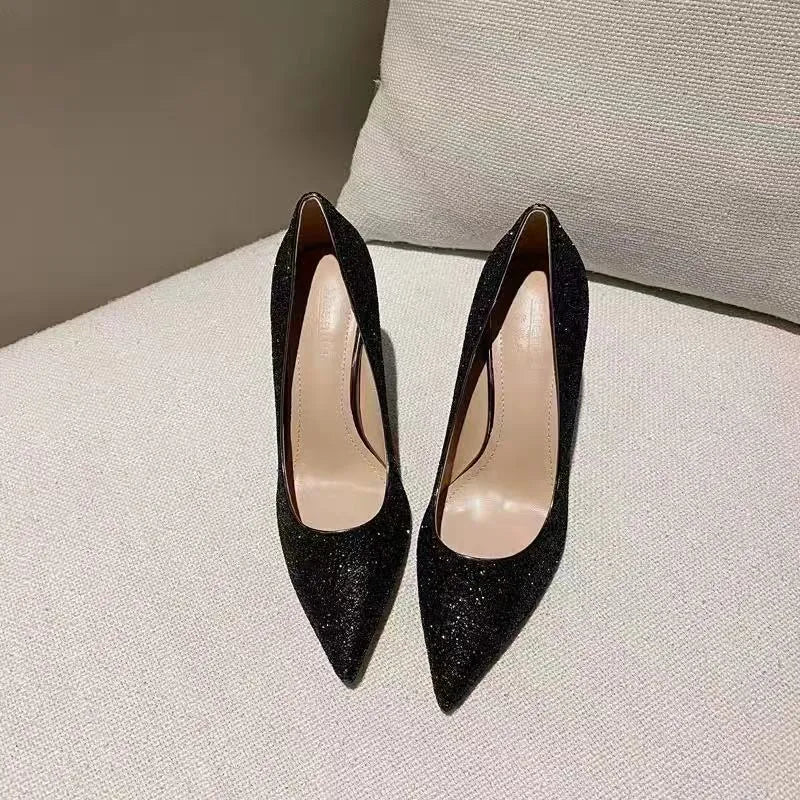 Women's silver and black bridal stiletto shoes with PU leather construction on a white background.