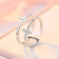 Double cross geometric women's ring with zircon stones on an adjustable copper band.