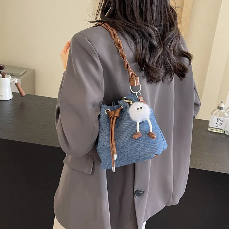 Blue synthetic leather cross body bucket bag with sandwich pocket and one-shoulder strap