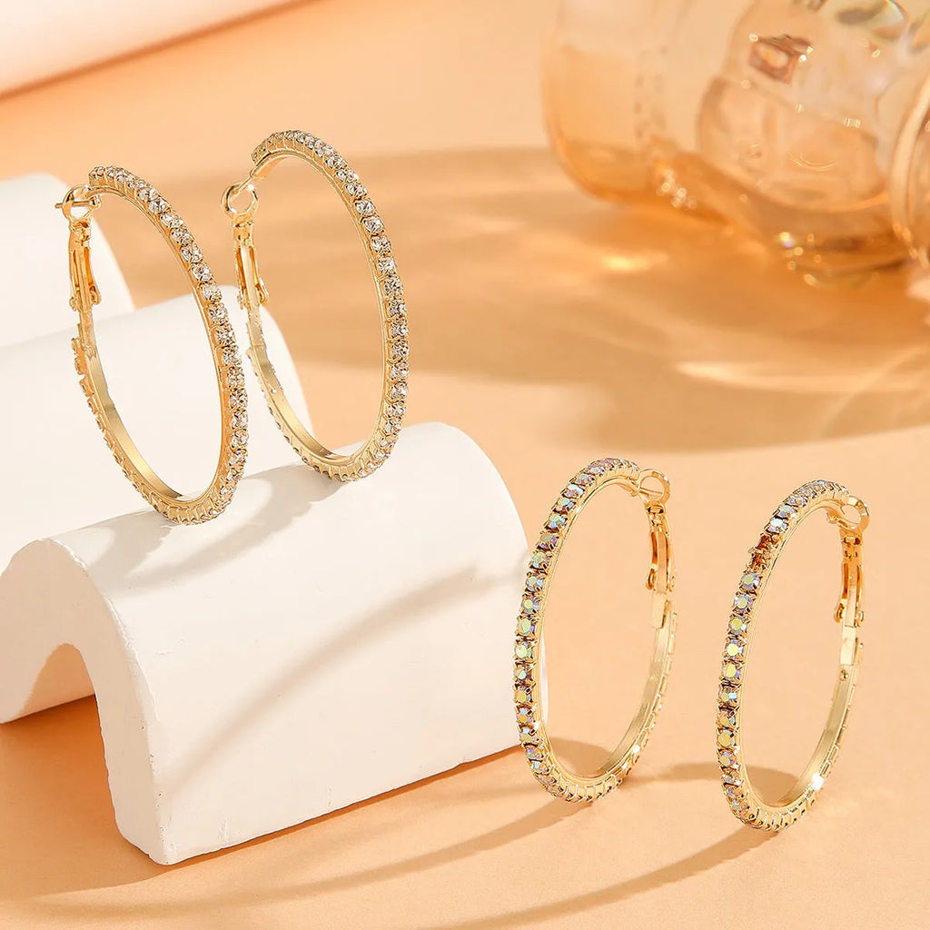 Large gold plated copper zircon hoop earrings for women, princess style, gold colour, on white background