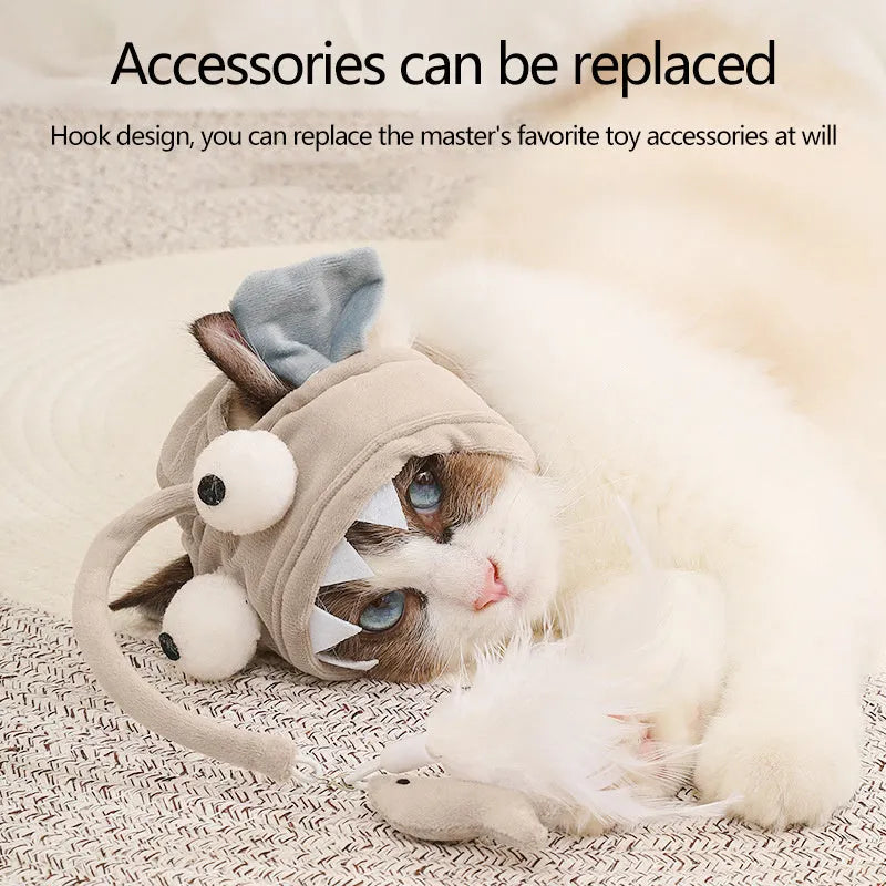 Grey dinosaur-themed head-mounted cat toy with feathers and big eye fish design on adjustable band