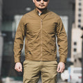 Man wearing a brown polyester tactics coat with a plaid pattern, showcasing its standard thickness and design.