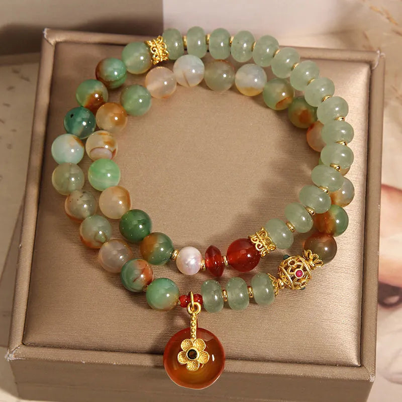 Women's peacock green agate double ring bracelet with alloy construction and safety buckle clasp.