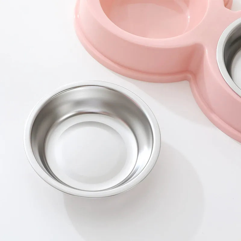 Stainless steel double compartment pet bowl for food and water on a silicone non-slip base.