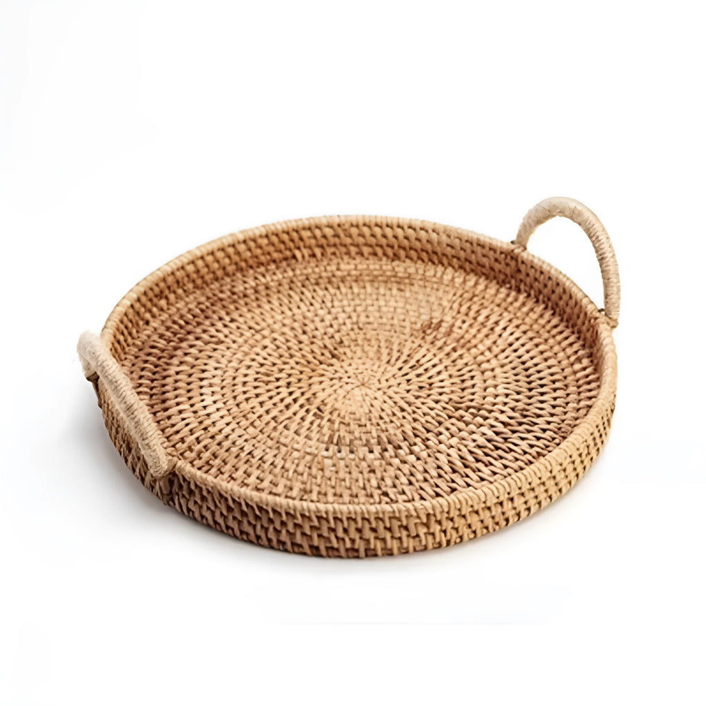 Round handwoven rattan storage basket with a wooden handle on a table.
