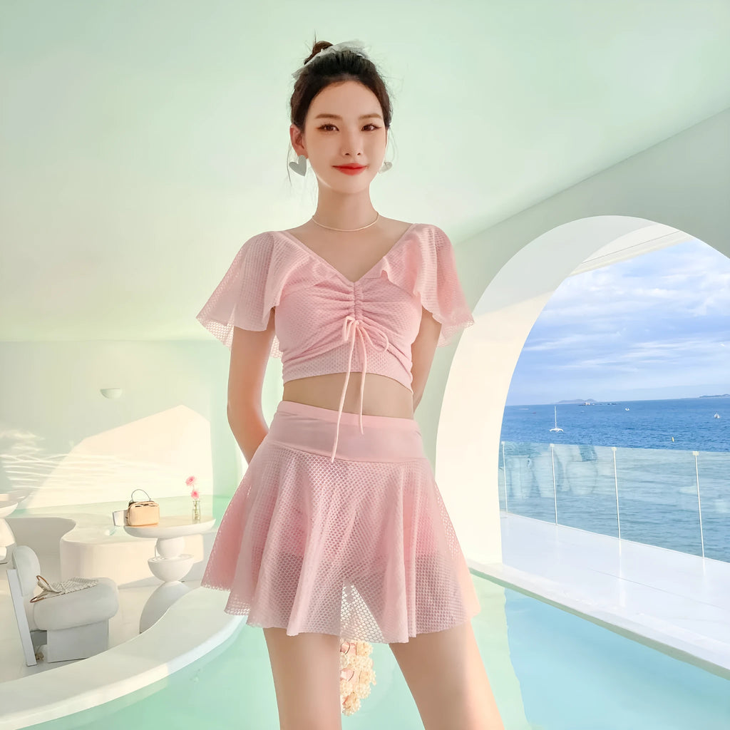 Women's solid colour two-piece swimsuit with a separate top and skirt.