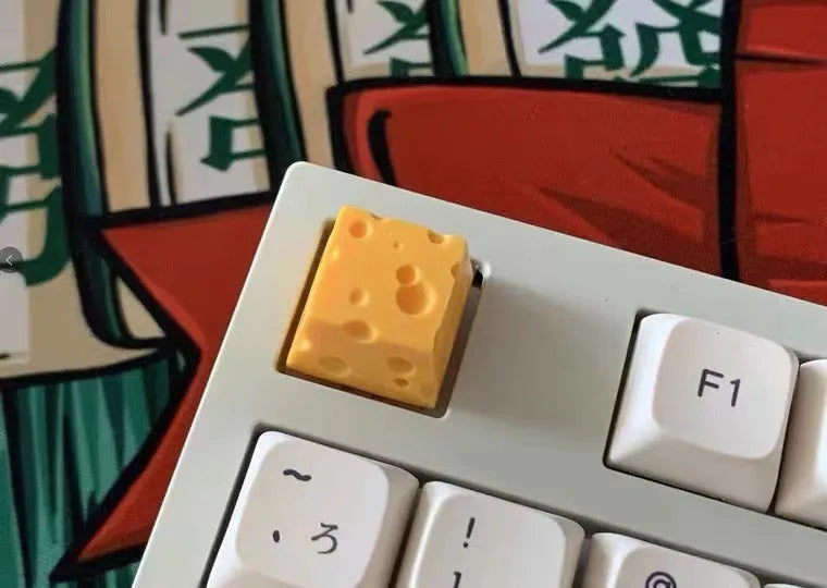 Yellow solid resin cheese wedge keycap for MX mechanical keyboards.