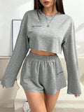 Grey women's long-sleeved T-shirt and matching shorts sleepwear set laid flat