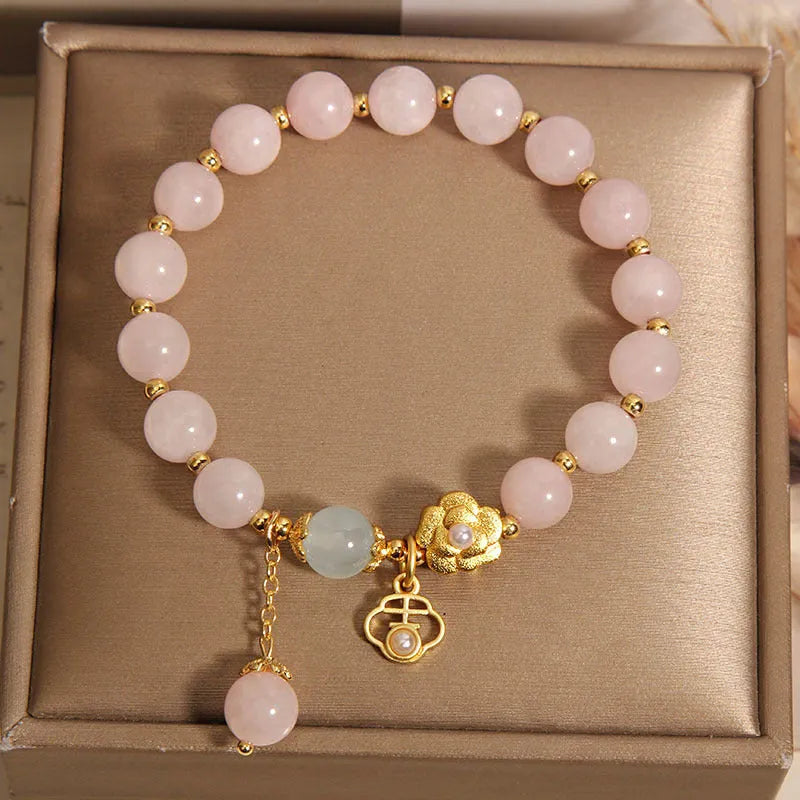 Women's pink crystal flower charm bracelet with delicate floral design