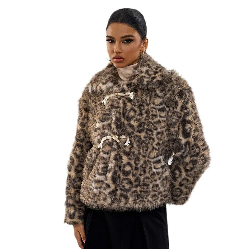 Women's leopard print coat with a buckle lapel fastening on a hanger.