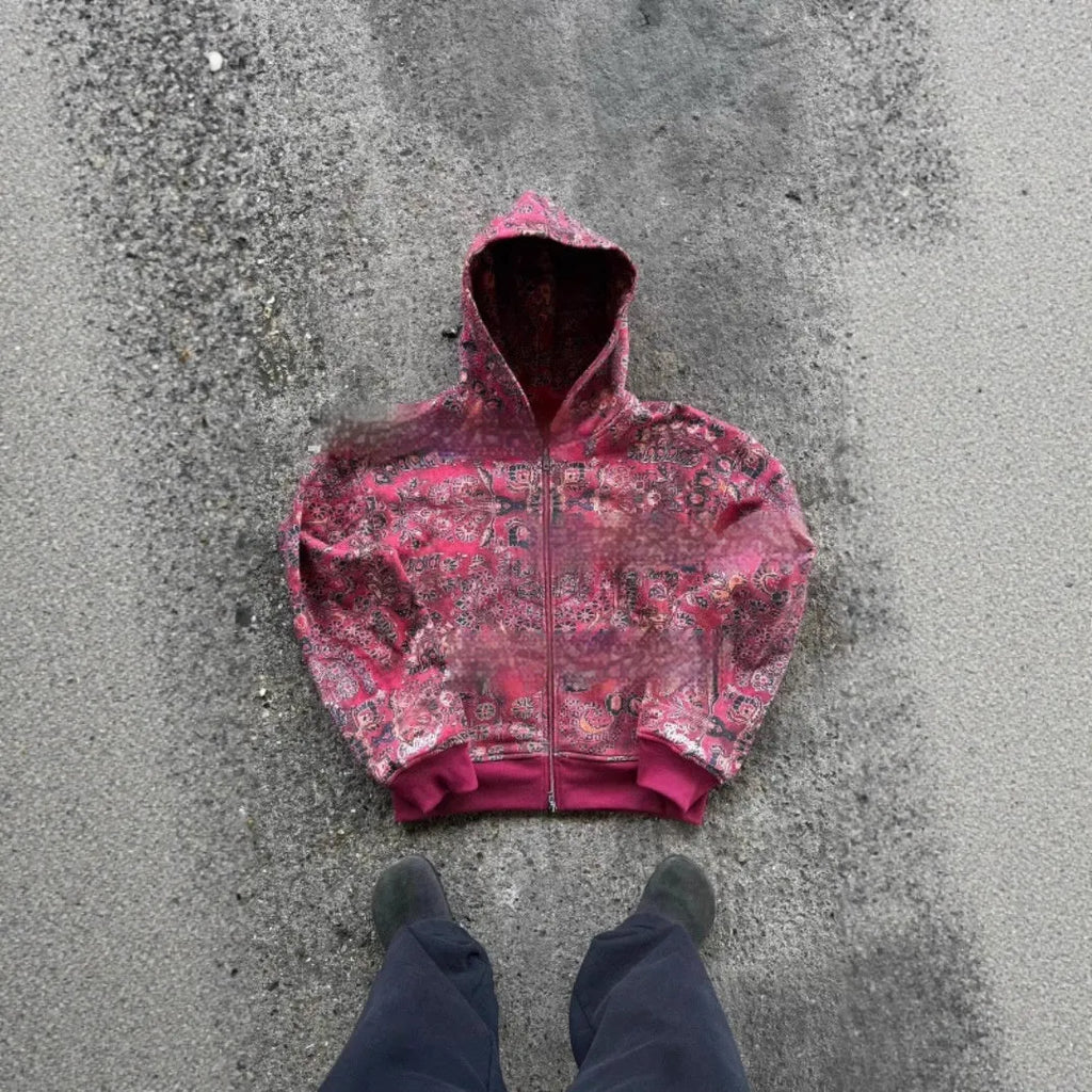 A red loose-fit men's hooded zip coat with long sleeves on a hanger.