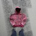 A red loose-fit men's hooded zip coat with long sleeves on a hanger.