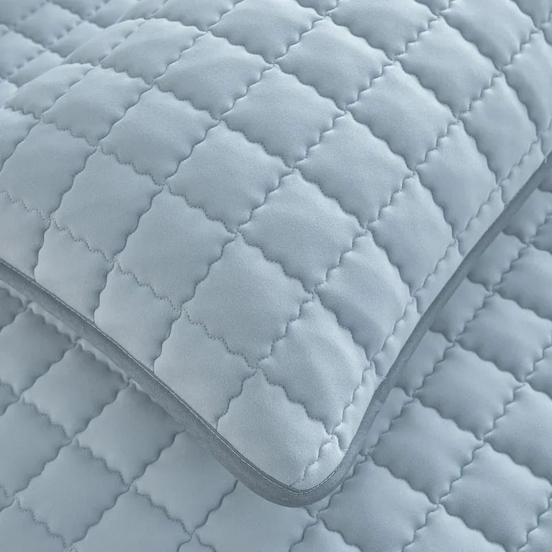 Class A waterproof fitted sheet in washed cotton, shown in a neutral colour on a bed.
