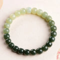 Natural Hetian jade bracelet with water gradient colour on polished beads.
