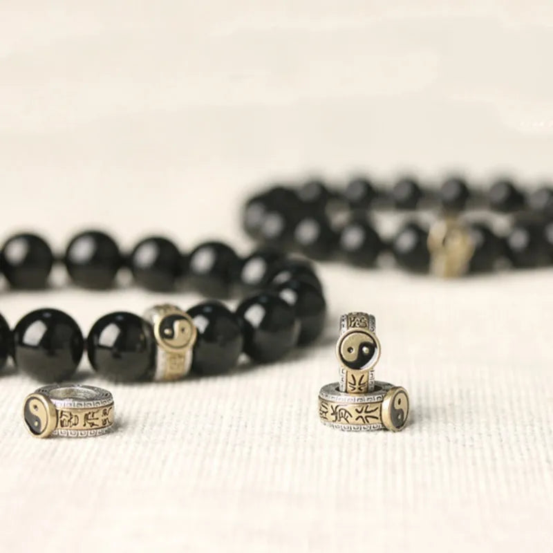 Black stone single ring bracelet for men and women on a wrist, showing 10mm and 12mm size options.