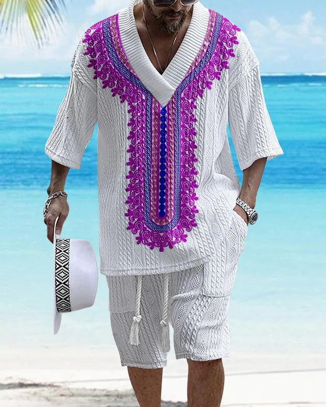 Man modelling a printed drop-shoulder knitted short-sleeved top with matching shorts in a casual setting.