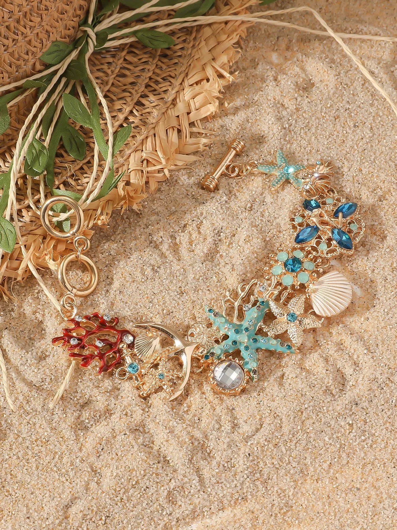 Women's alloy rhinestone nautical bracelet with starfish and anchor charms in turquoise, red, or blue.