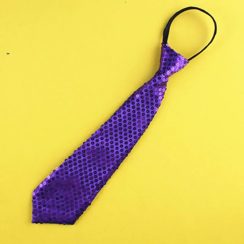 Gold sequin clip-on bow tie with striped pattern on white background.