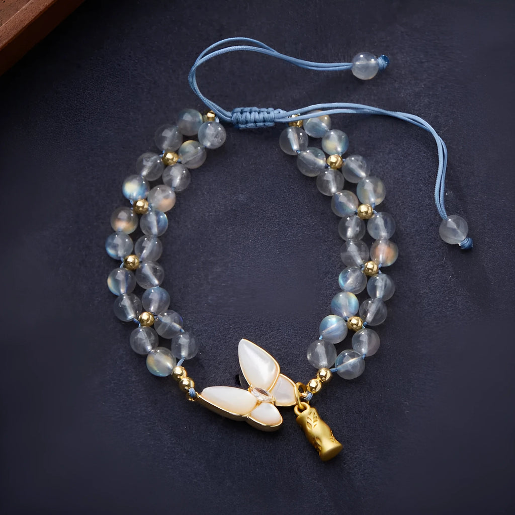 Grey moonstone woven bracelet with butterfly pattern and silver tone clasp