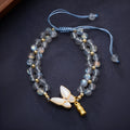 Grey moonstone woven bracelet with butterfly pattern and silver tone clasp
