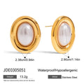 A pair of small stainless steel ear studs with a vintage-style pearl decoration on a silver-coloured base.