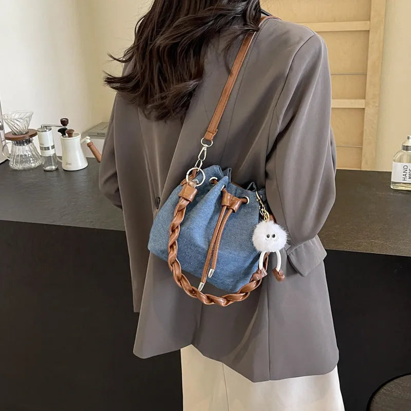 Blue synthetic leather cross body bucket bag with sandwich pocket and one-shoulder strap