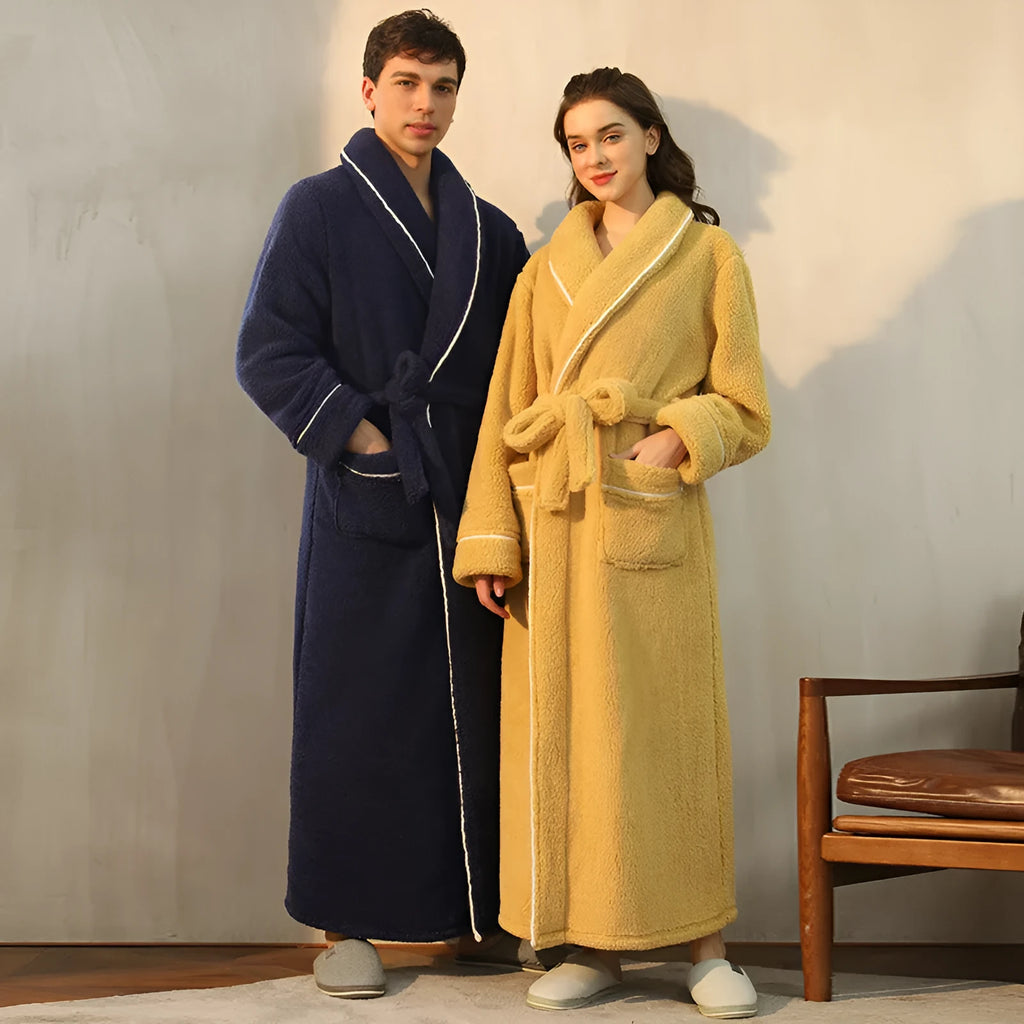 A man and woman wearing matching thick navy blue flannel bathrobes, ankle-length winter nightgown style.