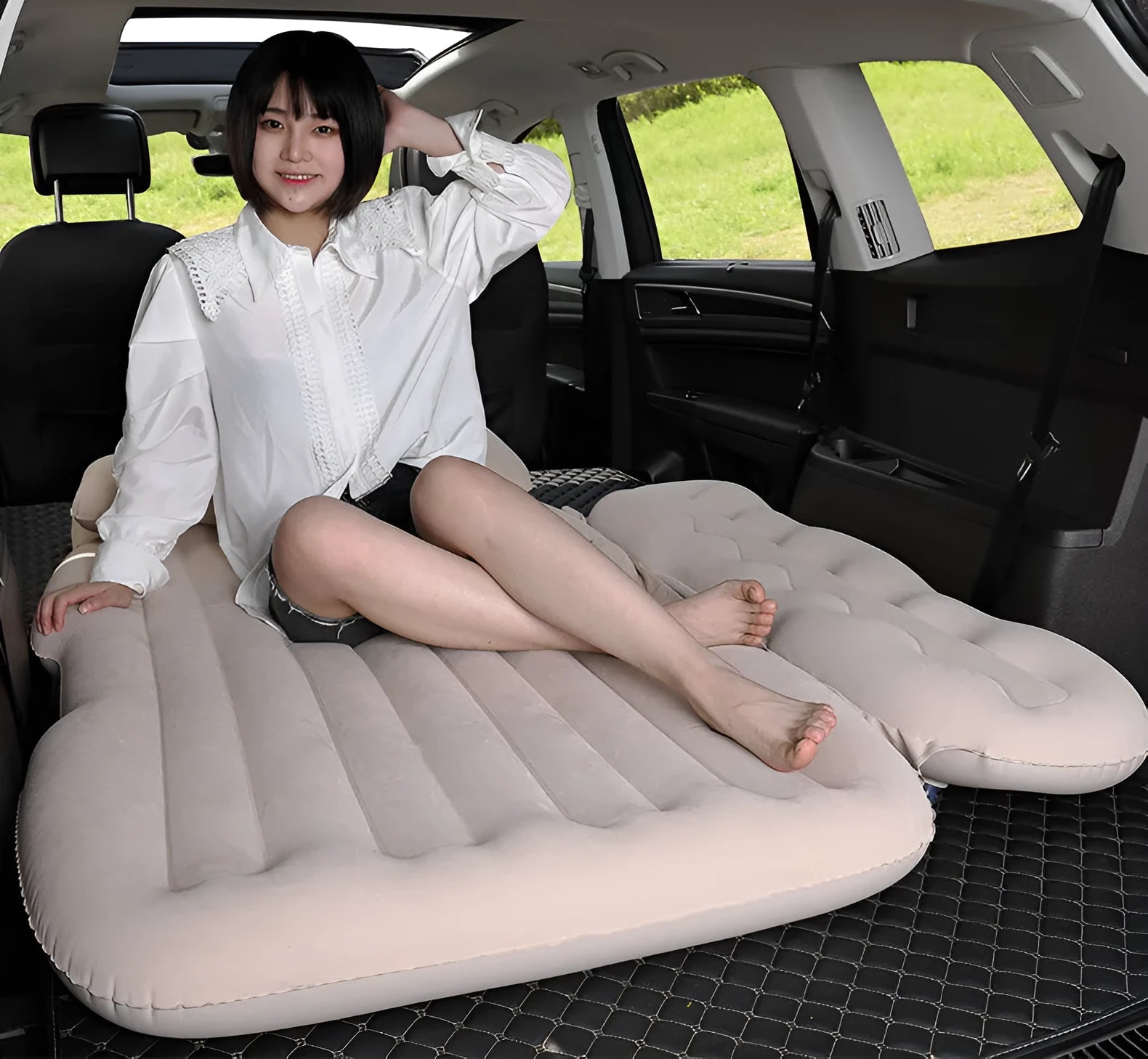 Inflatable car boot mattress with split design and grey flocked fabric, shown in an SUV rear.