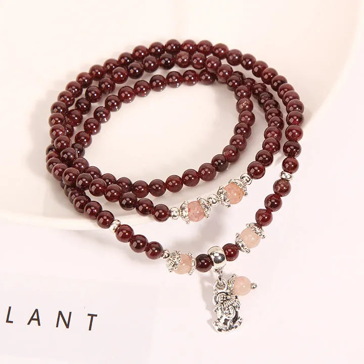 Women's Bohemian style crystal flower bracelet in wine red garnet and sauteed green beans colour.