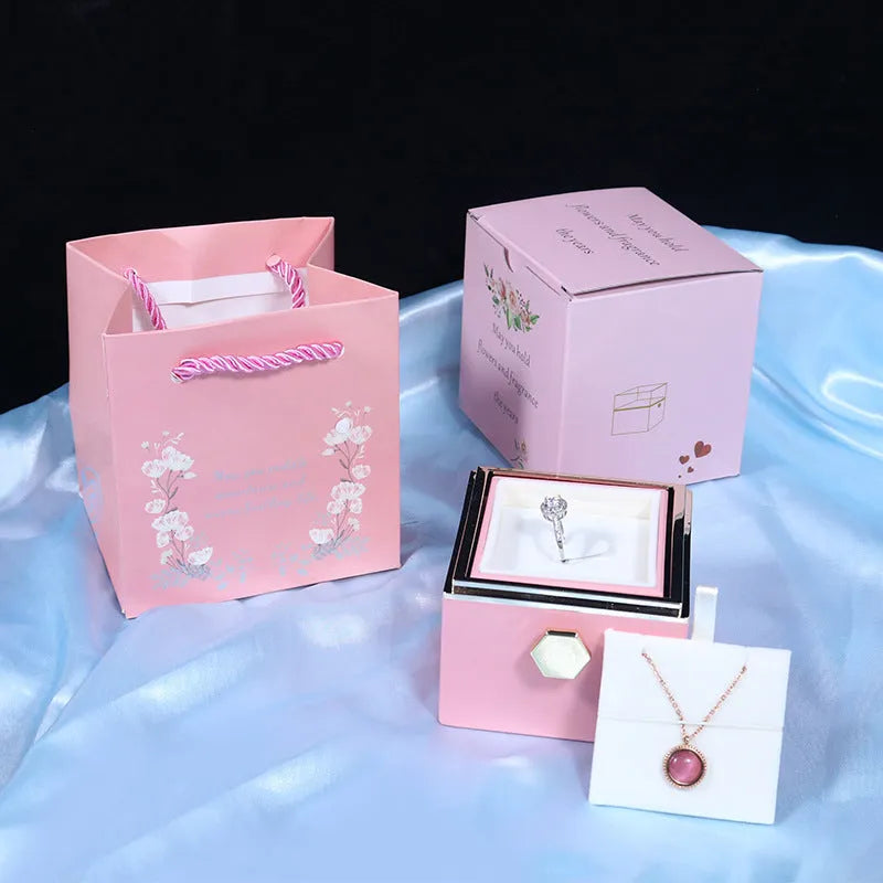 Rotating drawer jewellery gift box with red preserved rose under clear acrylic dome, showing open compartment.