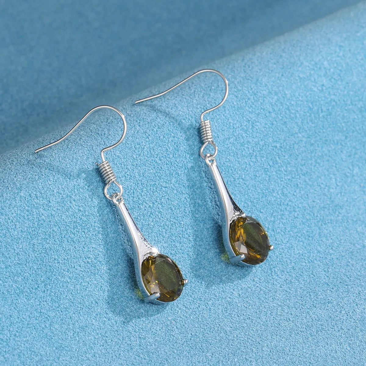 Olive green topaz colour earrings with water drop shape and retro style design