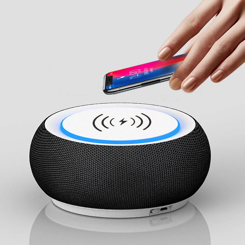 Black wireless Bluetooth speaker with dual speakers and subwoofer on a wooden table