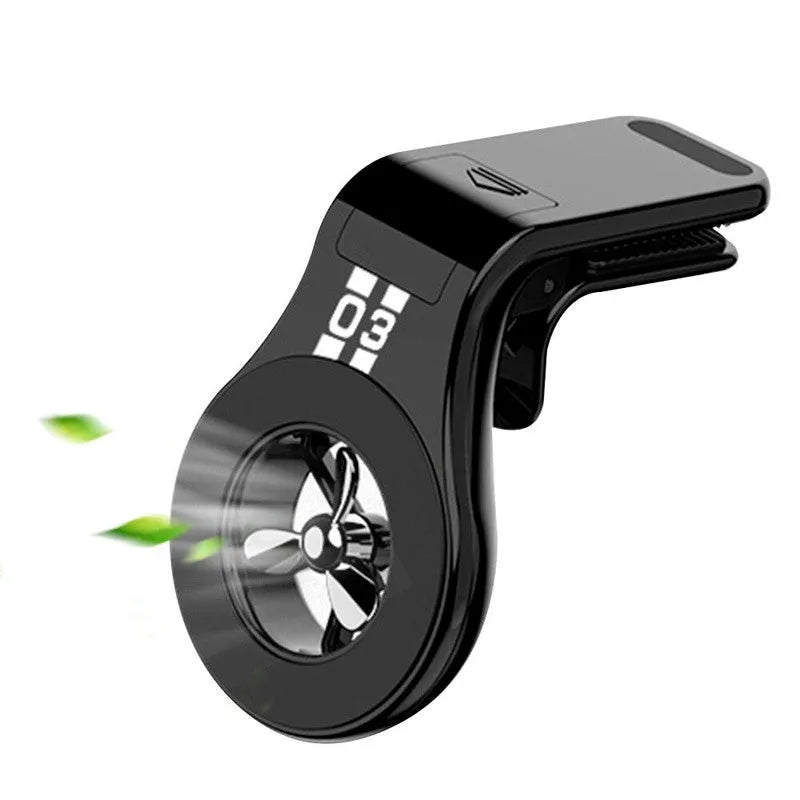 Black magnetic car phone holder clipped to a car air vent, holding a smartphone.